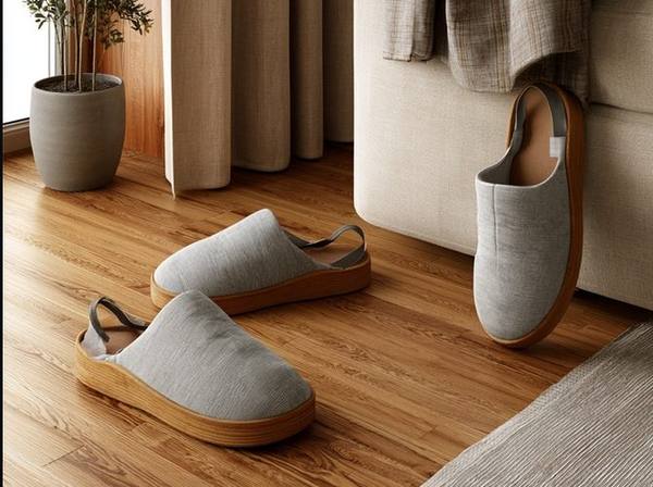 Non-slip house slippers with rubber sole and back strap on hardwood floor