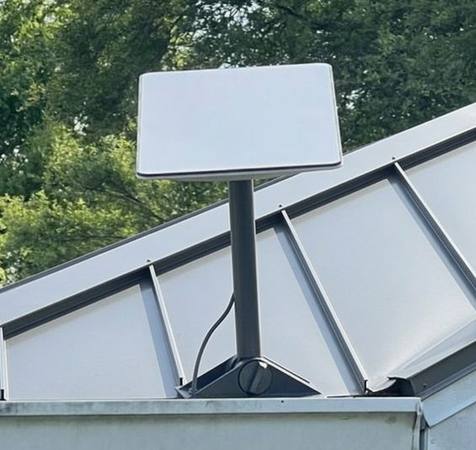 Real Starlink satellite dish mounted on a roof