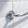 Chrome grab bar mounted on white tile